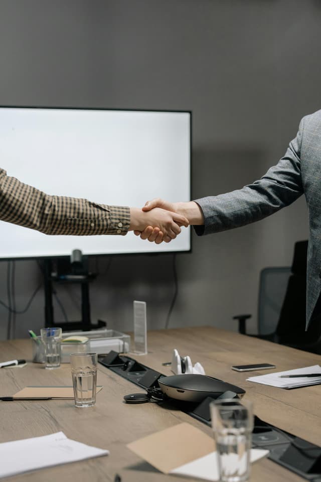 Client and squad shaking hands — without a definition of done, the handshake is theater